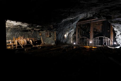 A large hoist sits next to the end of the shaft, to assist in mine operations.